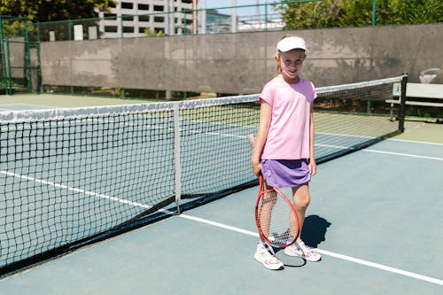 Free Girl in Sportswear Holding Her Tennis Racket Stock Photo