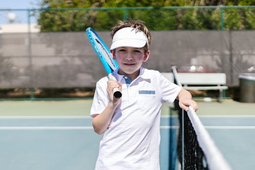 Boy Wearing Sportswear Standing by the Tennis Net