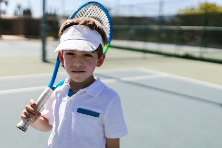 Boy In Sportswear Holding His Tennis Racket