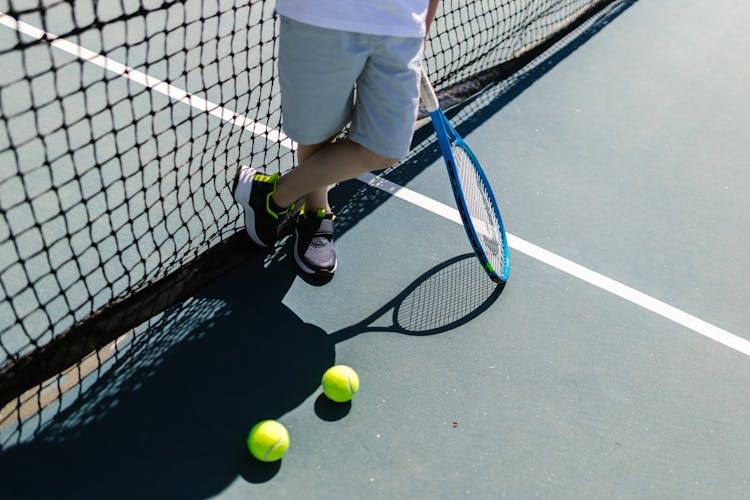 A Person Holding A Tennis Racket