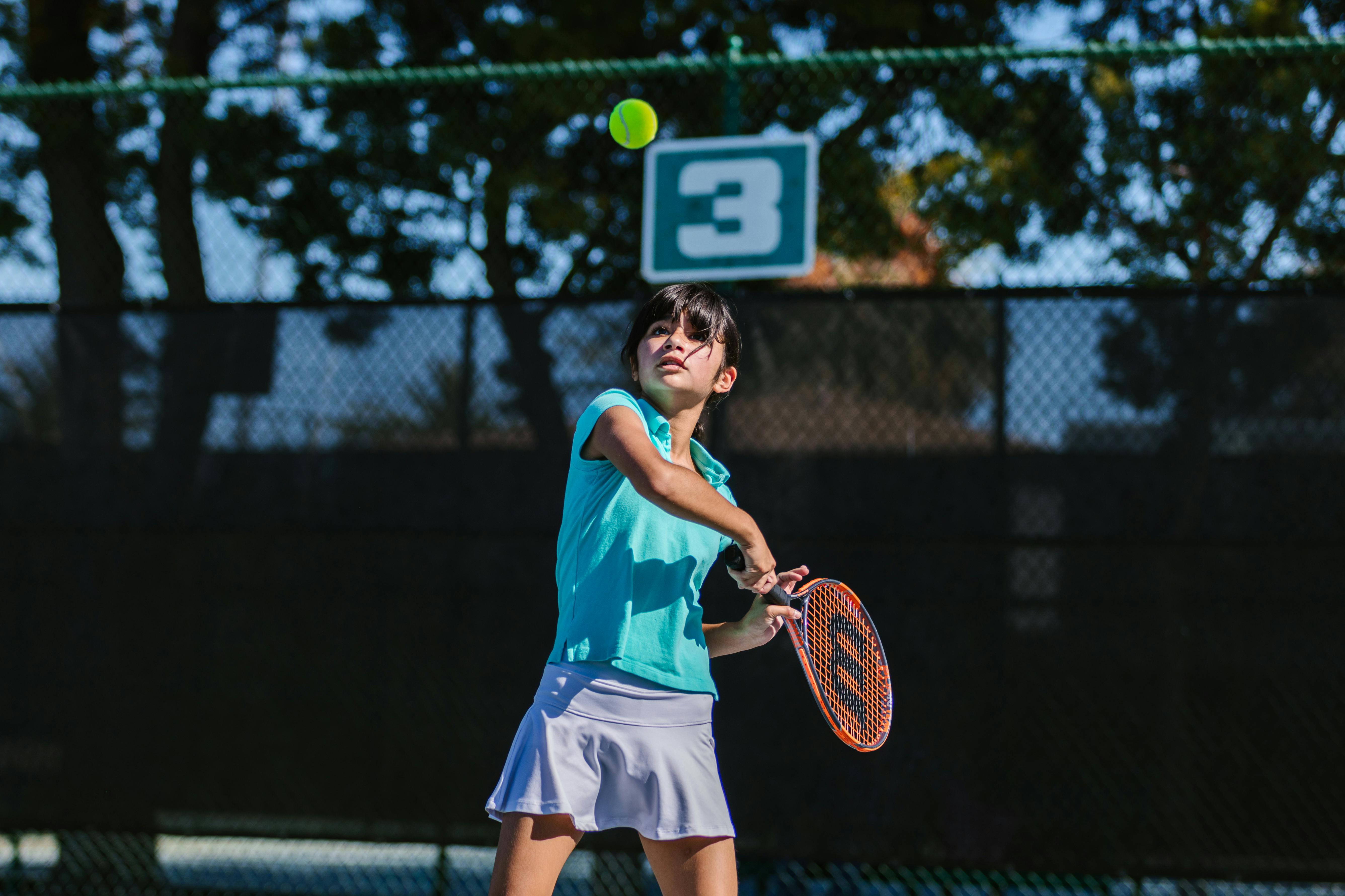 girl playing tennis