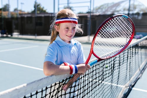 Girl Wearing Sportswear Standing by the Tennis Net