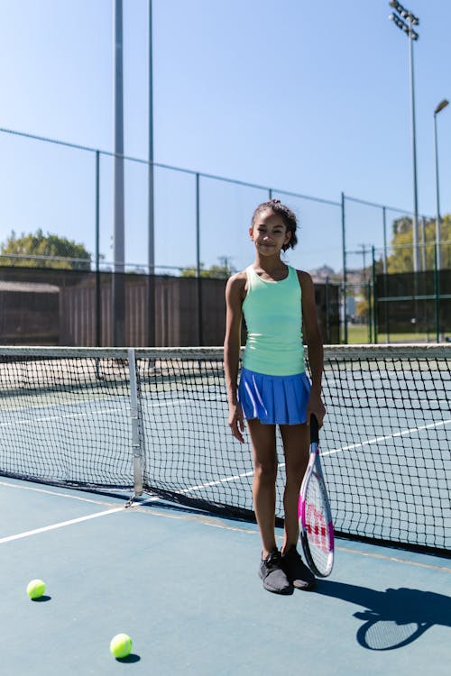 Girl Wearing Sportswear Standing by the Tennis Net