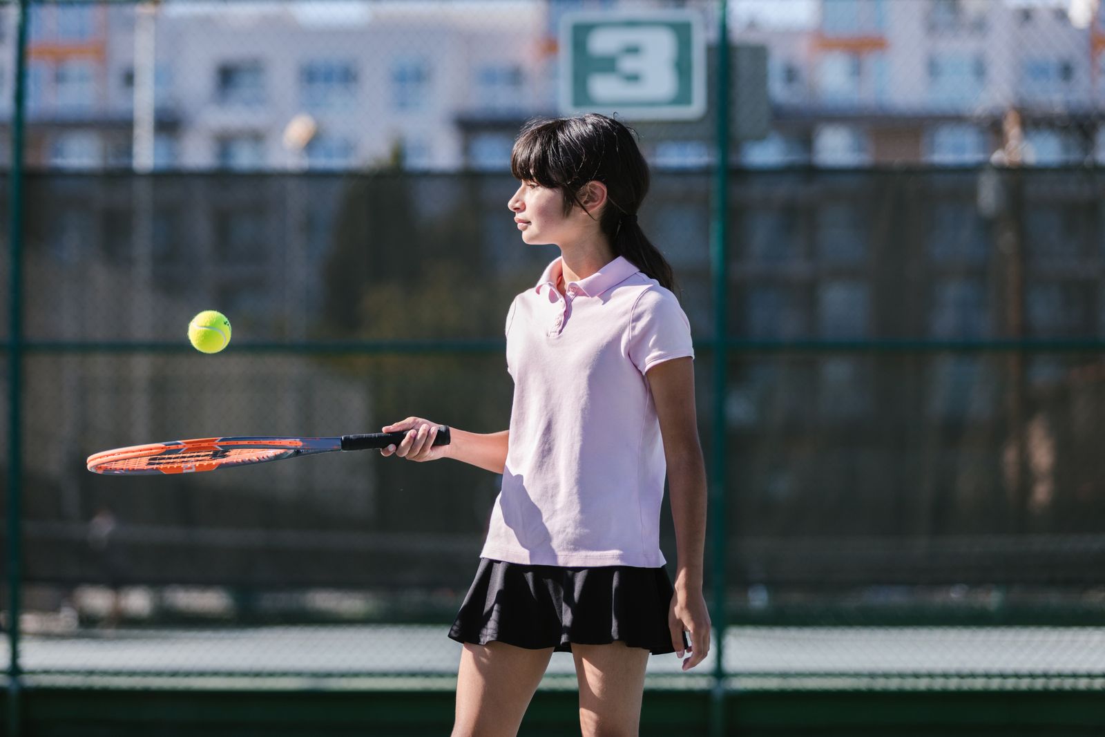 Tennis player preparing a forehand on a bright outdoor court