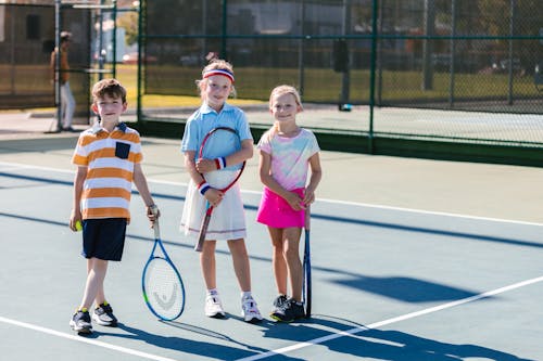 Free Kids Smiling on the Tennis Court Stock Photo