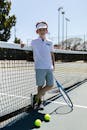 Boy Wearing Sportswear Standing by the Tennis Net