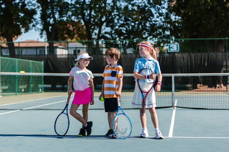 Kids Having A Conversation On The Tennis Court