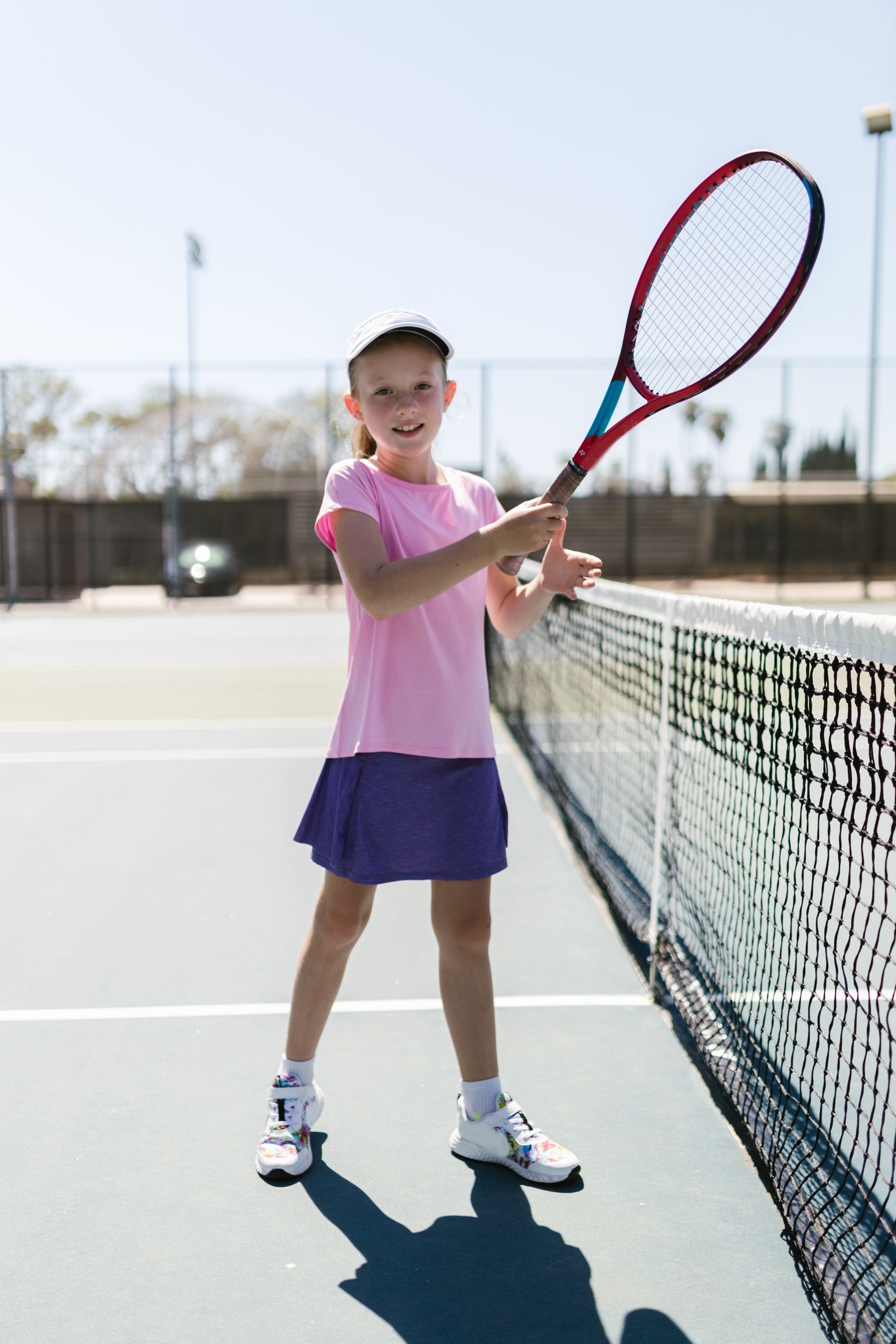 Tennis player preparing for a forehand outdoors with focus on elbow and forearm movement