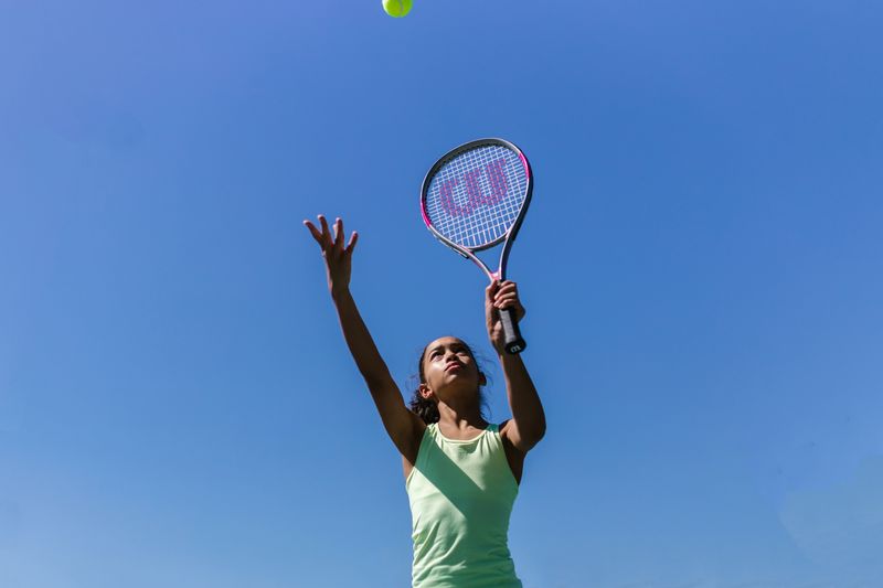 Tennis racket and ball on grass court