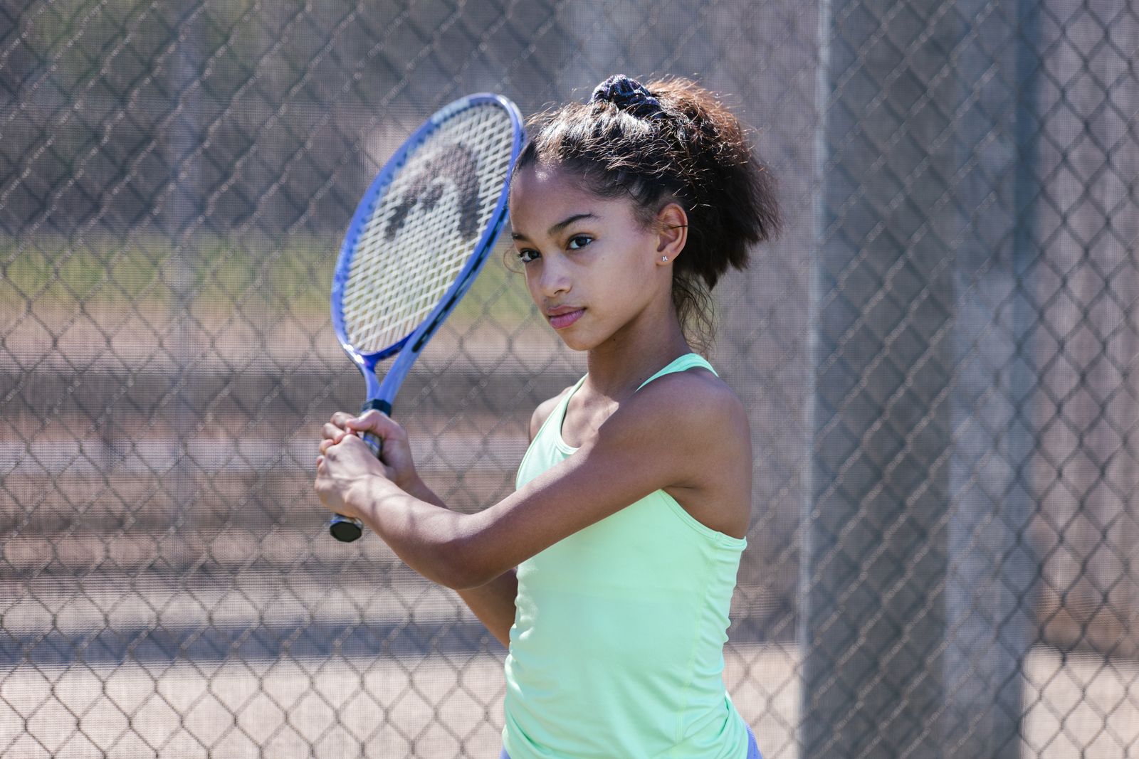 Pickleball player on a bright outdoor court preparing for a return