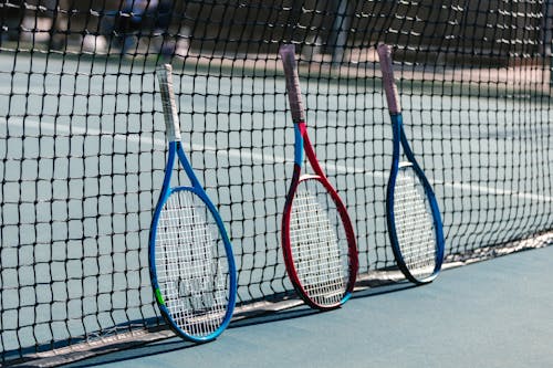 Free Tennis Rackets on Tennis Net Stock Photo