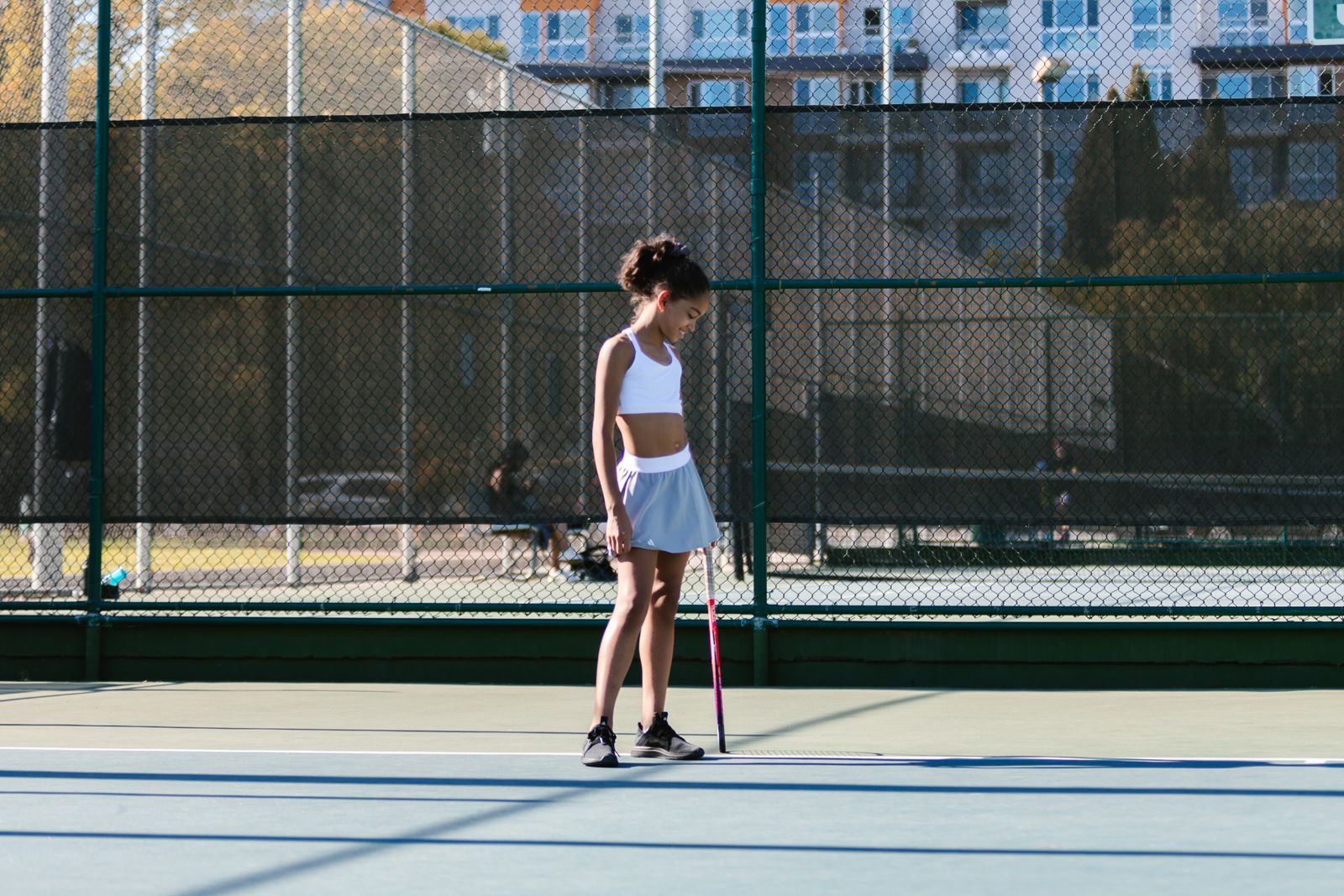 Tennis player holding a racquet on a bright outdoor court