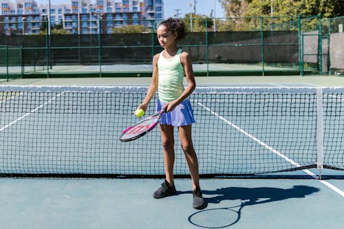 Free Girl Holding a Tennis Racket and Tennis Ball Stock Photo