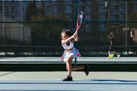 Woman in White Shirt and White Skirt Holding Tennis Racket