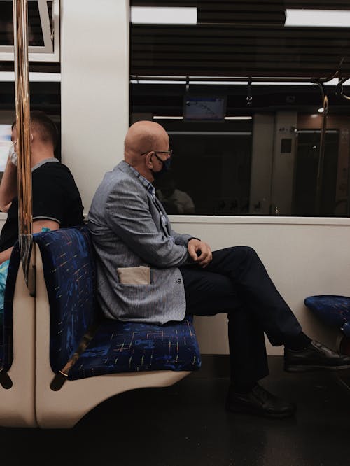 An Elderly Man Sitting on a Train