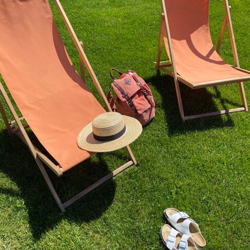 Two deck chairs and a sun hat on the grass — photo by Ann Zzz on Pexels
