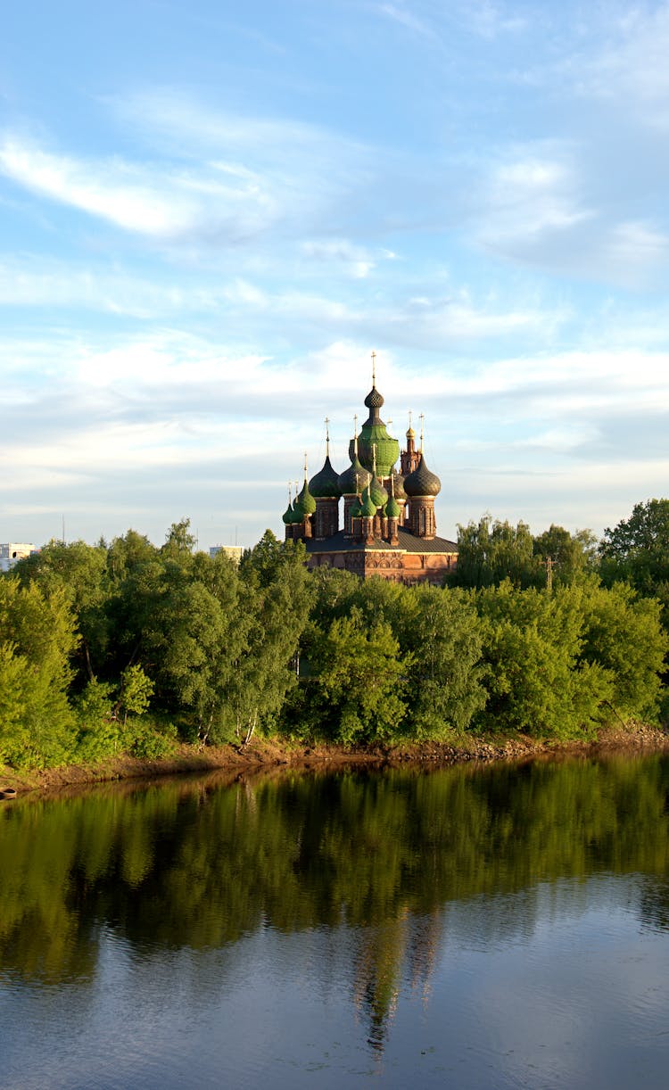 Church Near Water On Blue Sky Background