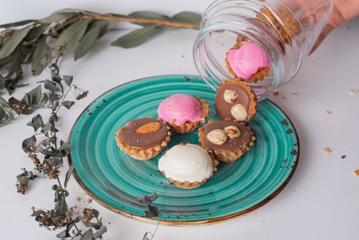 Close-up of assorted mini cupcakes on a vibrant plate, perfect for dessert-themed visuals.