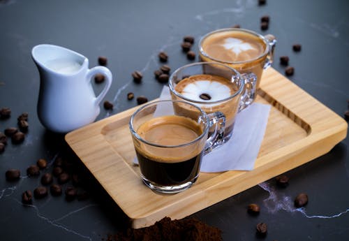 Free Glass Cups With Coffee on Brown Wooden Tray Stock Photo