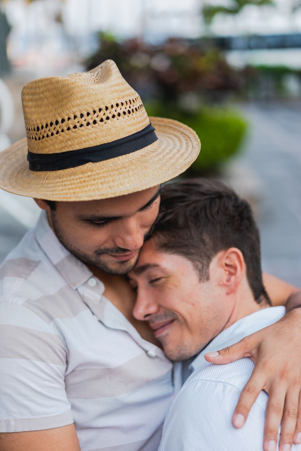 Two adults embracing in a warm outdoor moment