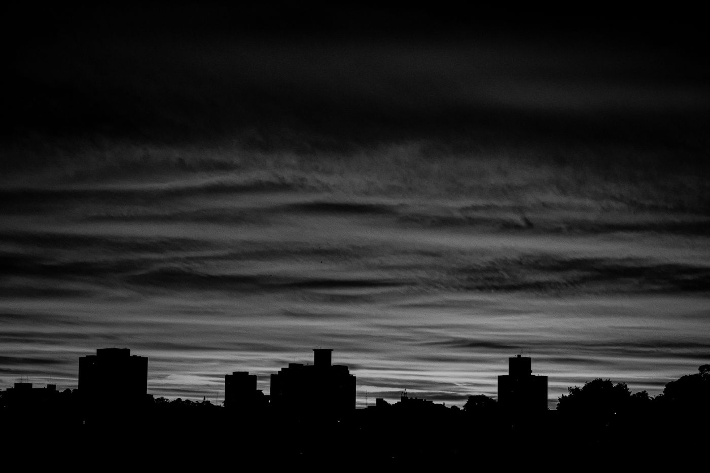 Dramatic black and white city skyline silhouette at twilight