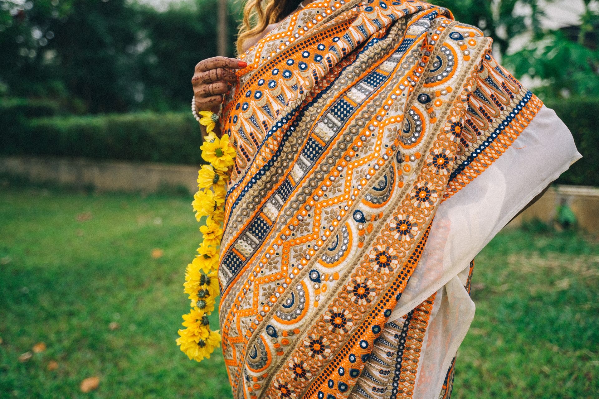 Close-up of a colorful traditional Indian sari paired with marigold flowers, capturing the essence of Indian culture.