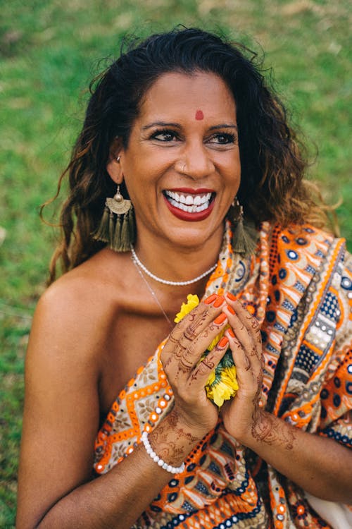 Smiling Woman Holding Yellow Flowers