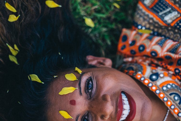 Woman In A Traditional Saree Dress Lying On The Grass And Smiling 