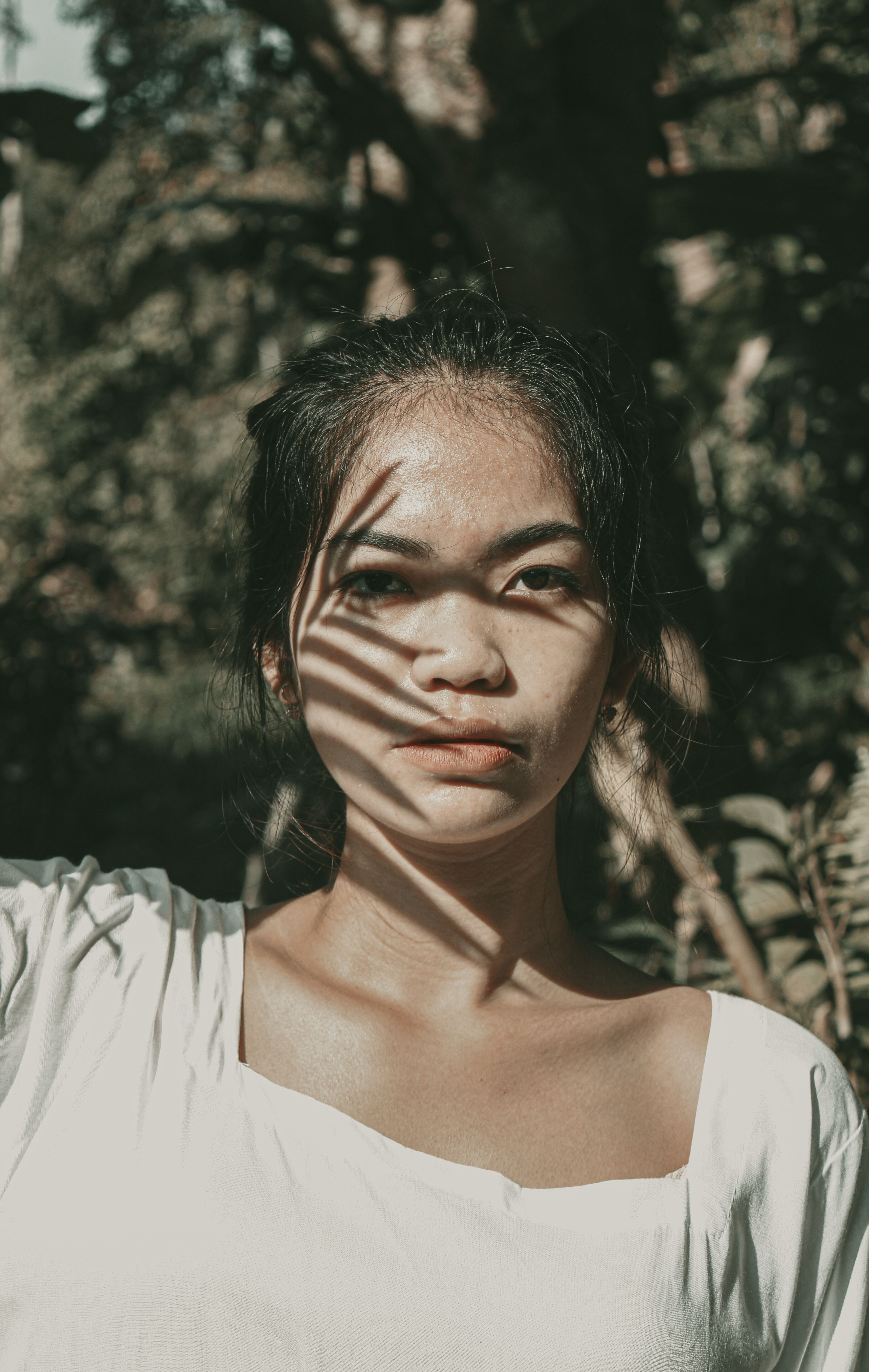 A Woman in White Shirt Looking with a Serious Face · Free Stock Photo