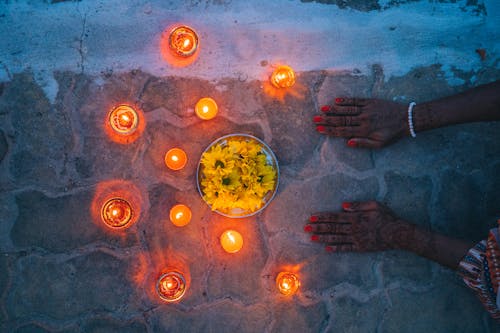 Free Burning Candles and Yellow Flowers Stock Photo