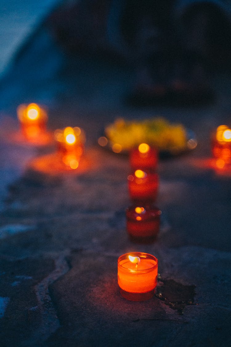 Lighted Canldes On A Stone Surface 