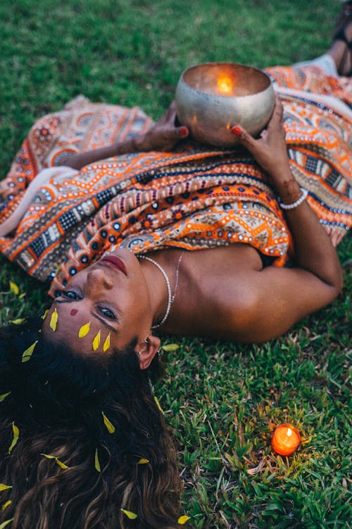 Beautiful Woman in Traditonal Wear lying on Grass