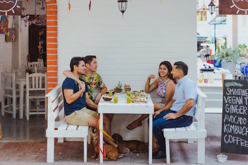 Free A Couple Eating in a Restaurant with Friends Stock Photo