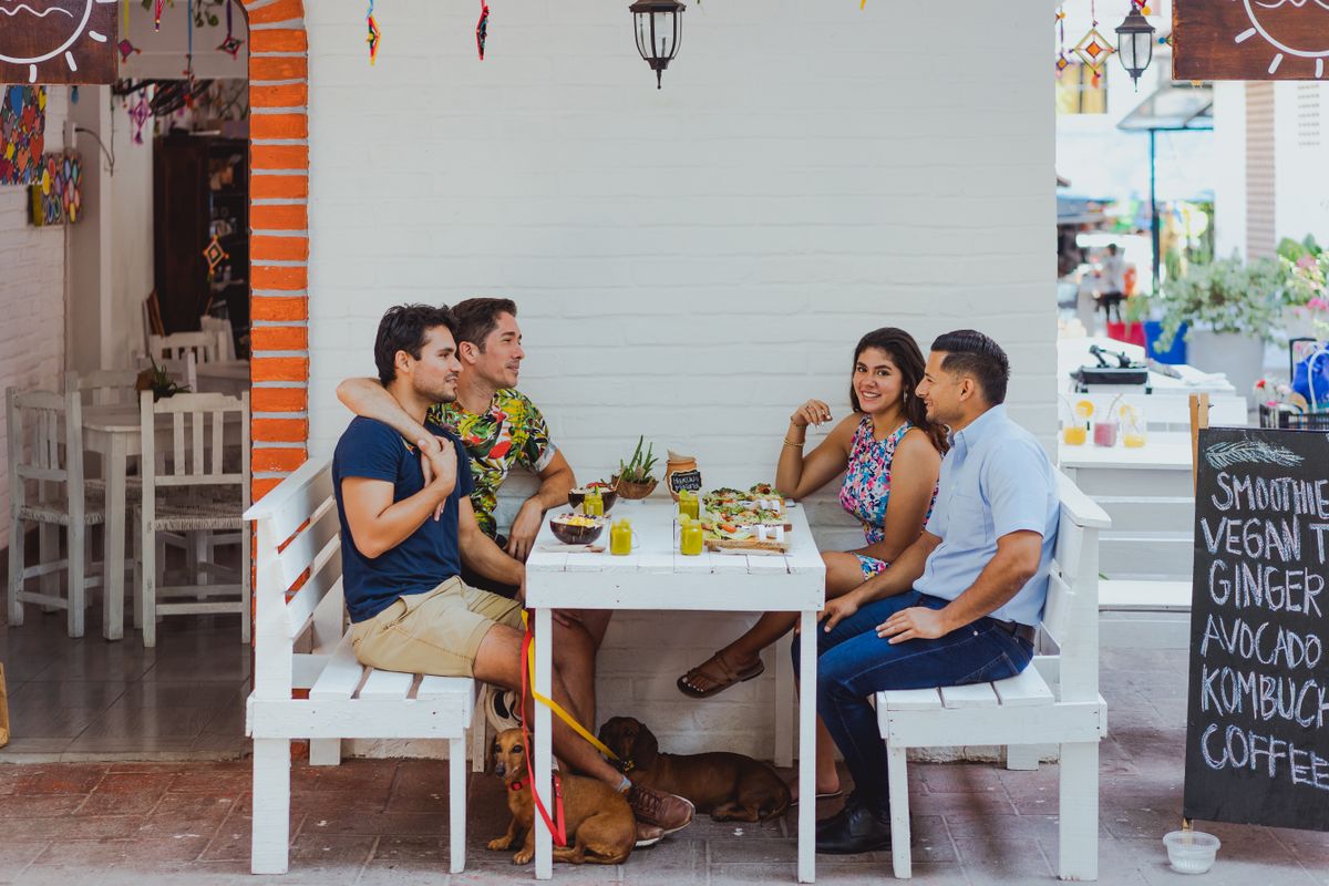 Friends enjoying a restaurant meal and saving money on dining