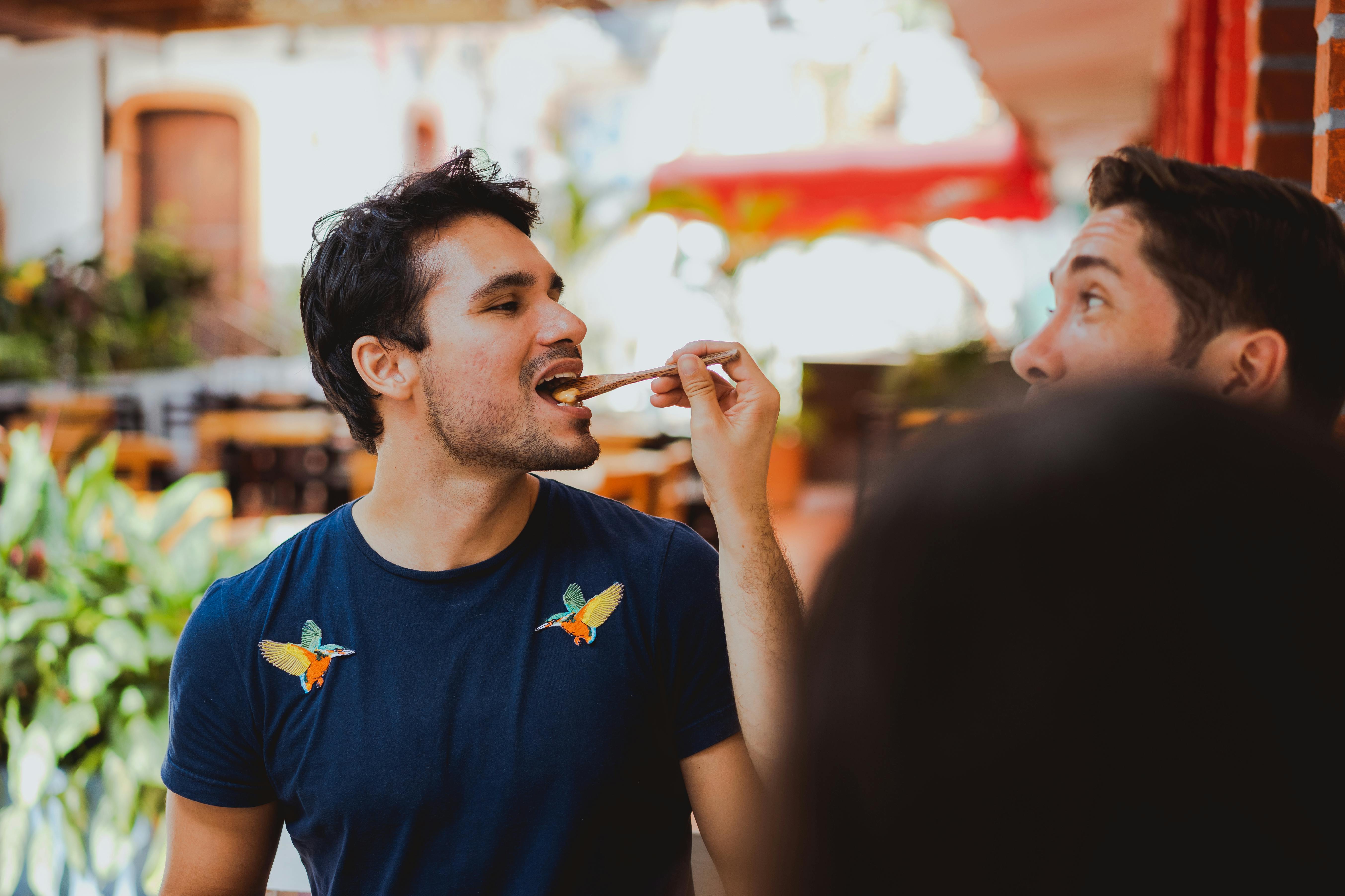 a man feeding a man