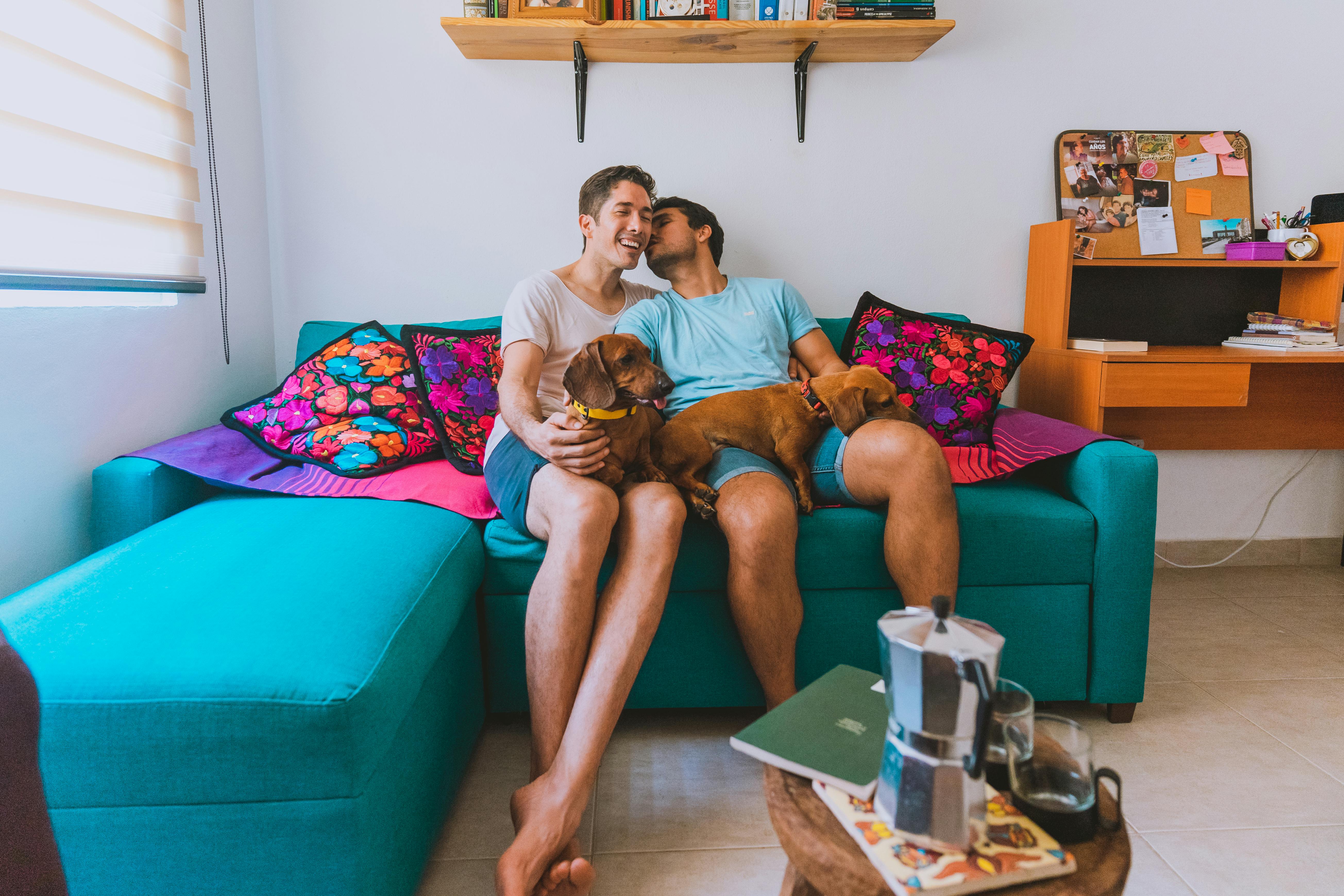 man and woman sitting on blue couch