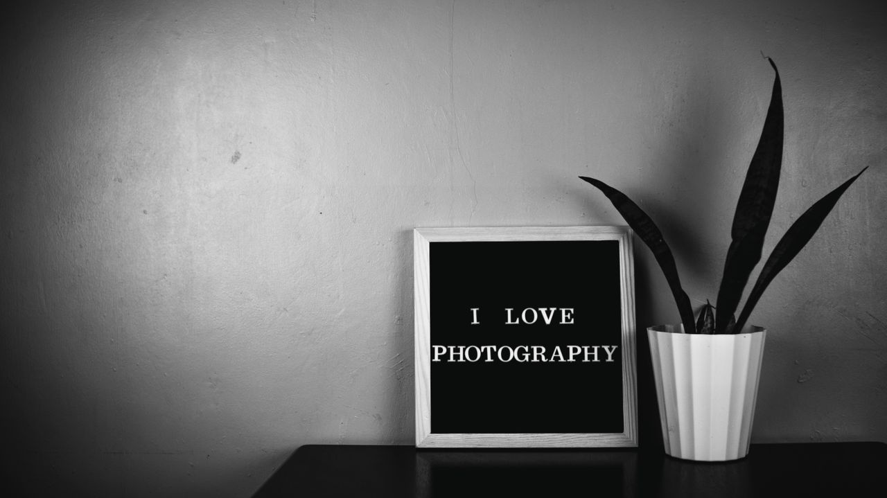 monochrome image featuring a message board with i love photography and