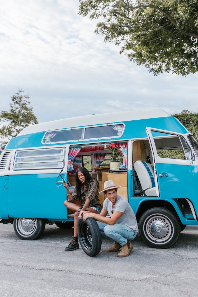 A Couple With A Spare Tire Beside A Mobile Home