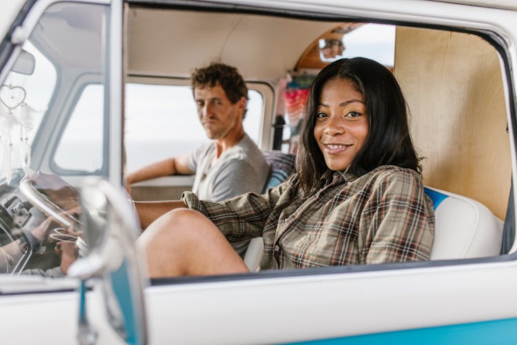 Man And Woman Sitting On White Car Seat