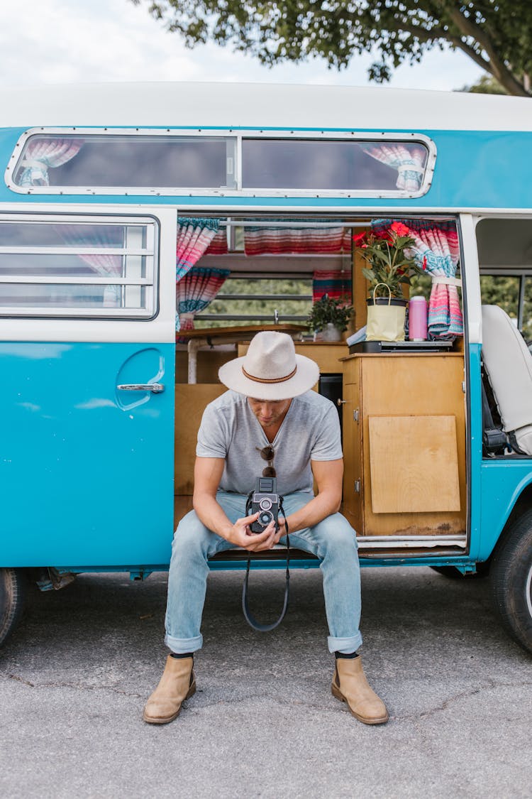 A Man Sitting On The Van