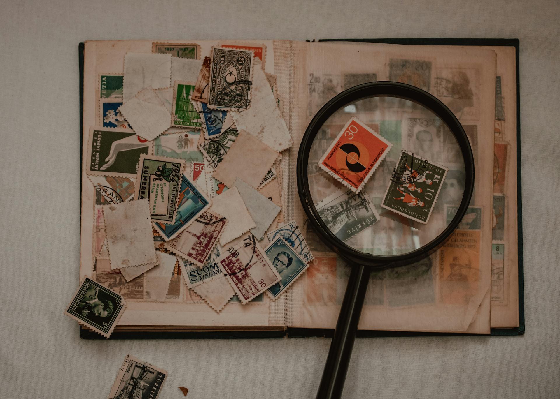 Black Magnifying Glass on White Printer Paper with Stamps