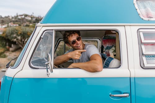 Man in Sunglasses Sitting in a Campervan 
