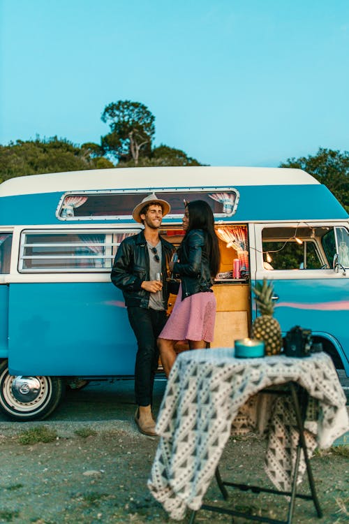 A Couple Standing by an RV