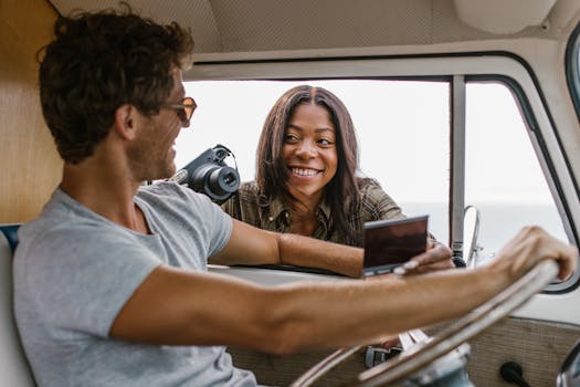 Happy couple on a road trip, enjoying van life and capturing memories together.