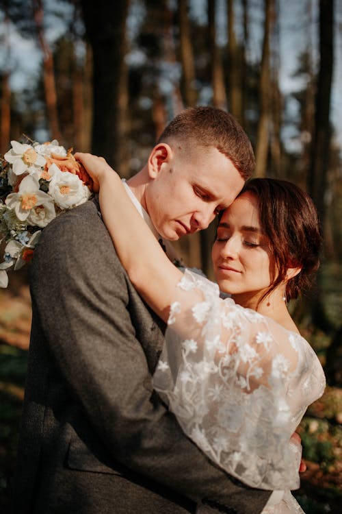 A Couple Hugging While Eyes Closed 