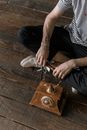 Crop man sitting on wooden floor