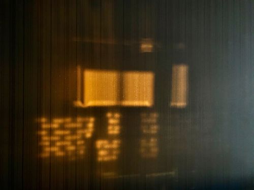 Free Warm sunset light casting abstract shadows on a textured wooden wall panel. Stock Photo