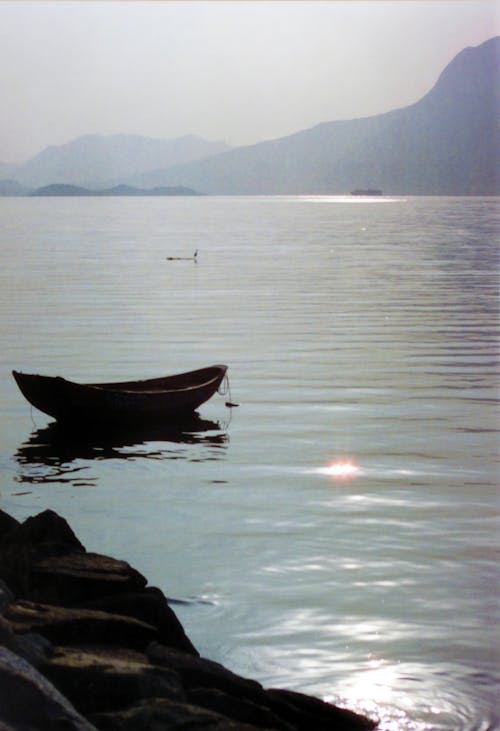 Black Canoe on Body of Water