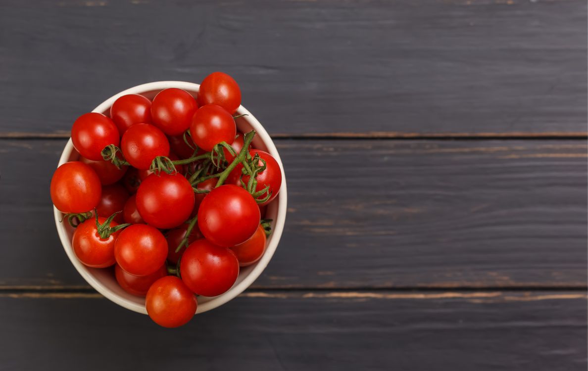 A Bowl of Fresh Red Tomatoes on a Wooden Table · Free Stock Photo