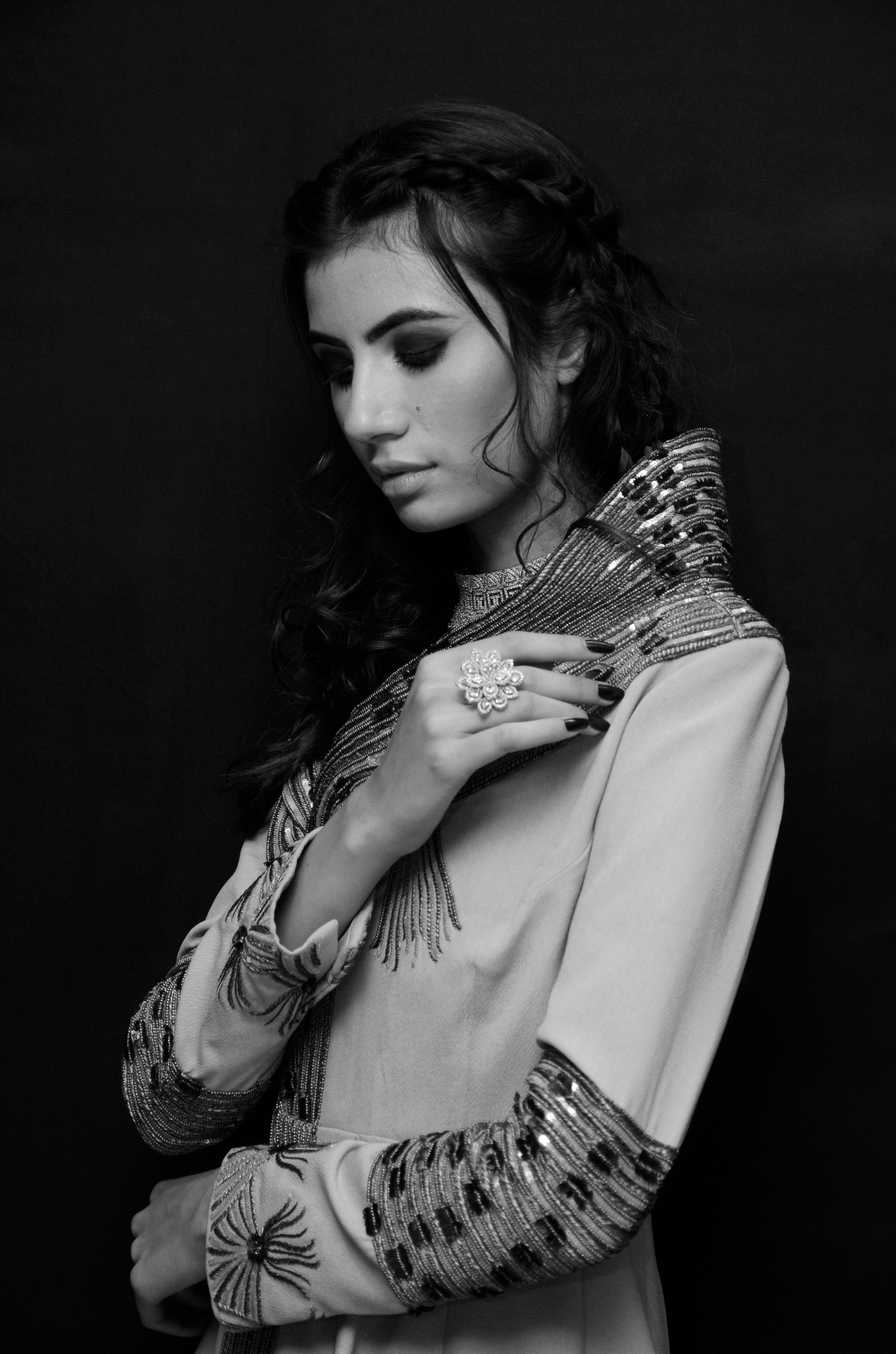 Grayscale Photo of a Woman in Black Outfit Sitting on White Chair ...